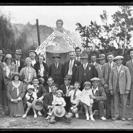 Group portrait of people in front of Māori gateway during Waiuta jubilee.1931.