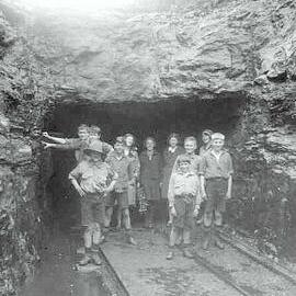 Group portrait of unidentified children and women at the entrance of a Coalmine, West Coast. ca.1910s-1930s