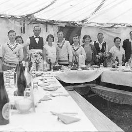 Group portrait in interior of marquee prepared for sit-down meal during Waiuta jubilee