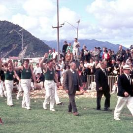 Two six-man teams being led out into the Greymouth Industries Fair chopping ring by Ralph Dickson Snr.1969.