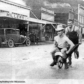John Crossman pushing Percy Dellaca along Broadway in the procession.1960.