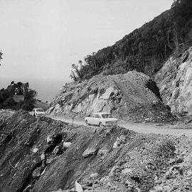 Cars on a partially completed section of the Haast Pass highway.1966.