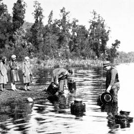 Men stocking quinnat salmon in Lake Ianthe.1932.