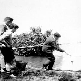 Mack, Wallace and Ashley Wells  whitebaiting in the Hokitika river -  with the net.