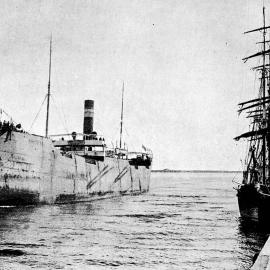 The big collier Steamer 'Breconsire' on the Buller River coming alongside to load coal for overseas markets.Westport.1907.