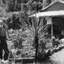 Mr Otto Arndt in front of his house and garden near Lake Mapourika .1936.