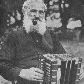 Gold miner Joe Vrobifski relaxing with his accordion at Kanieri, Westland.