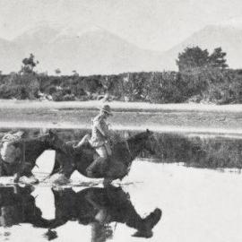 Fording a stream soon after leaving the settlement of Okuru.1930.