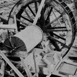 The waterwheel turns a drum containing mercury which helps separate the gold. Addison`s Flat.1940.