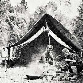 Solving their own problems of unemployment  - young gold prospectors cooking outside their camp West Coast. 1932.