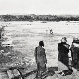 Blackball residents waiting to cross the broken bridge on the Ropeway.1926.