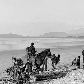 Unidentified group viewing aircraft in flight at Bruce Bay, South Westland.1939.