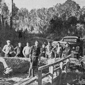  A gang of men removing one of several large trees blown down across the road near Bruce Bay during a recent gale.1938.