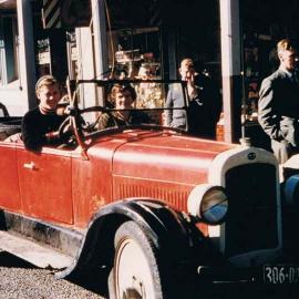 Peter Rafferty at the wheel with his mum Laura in his 1928 Oakland 6 open top tourer.Hokitika.Early 1960`s.
