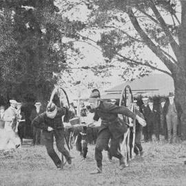 THE HOKITIKA FIRE BRIGADE ENGAGED IN THE MODERN FIVE-MEN EVENT AT THE FIRE BRIGADE ASSOCIATION'S ANNUAL DEMONSTRATION AT TIMARU.1915.
