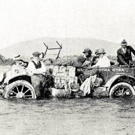A car stuck in the Little Wanganui River, Westland.1922.