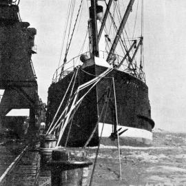 The Waimea at Greymouth wharf with extra cables out and engines running full speed ahead during a flood.1936.