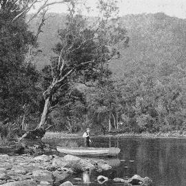 A man in a small boat on a river on the West Coast.1907.