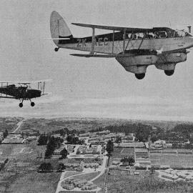 Aeroplane flying over the Westland Hospital at Hokitika, en route from Hokitika to Greymouth.1937.