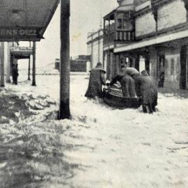  People pushing a boat along flooded Albert Street in Greymouth.1936.