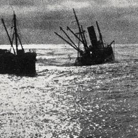 A coastal vessel crossing the bar at sunset - On the right is the steamship Kaponga, formerly a union Steam ship Company collier, which is fast breaking up.1932.