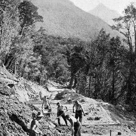Carving a highway through mountain and bush -  initial work on the new Hollyford-Okuru Road.1938.