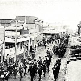 The unveiling of a memorial to Westland pioneers with a procession passing down Revell Street, Hokitika.1914.