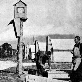  The camp clock at the main construction camp beside the Mahitahi River, Bruce Bay.1937.