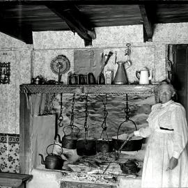 Inside Hende house at Hari Hari -  A typical kitchen of the time. note two guns on each side of a ceiling joist.1911.
