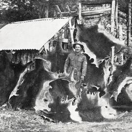 A prospector photographed outside his log cabin at the Golden Hope settlement  on the Maggie and Maud goldfield, Murchison district.1933.