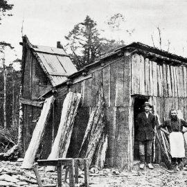 Prospectors beside their hut on the Howard Goldfield, Murchison District  -  The planking for the hut was all hewn by hand.1933.