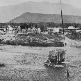  A lorry fording the Jacobs River, South Westland, with a load of fat lambs from a nearby station.1938.