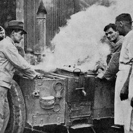  Soldiers and cooks stand around a new army portable stove, used for cooking on the Army Service Corps' trek from Christchurch to the West Coast.1938.