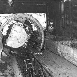 A rotary tipper empties coal from the mine tubs to be carried by belt feeder into the hopper.Strongman Mine. August 1976.