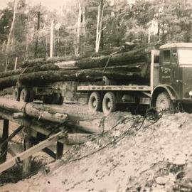 Crofts 1942 ex Army Hippo on a bush bridge with a long load. Ron Hartill driver.