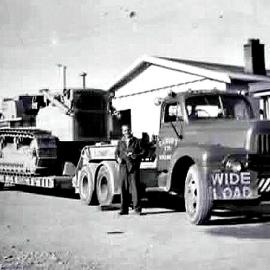 Basil Piner`s dozer on the back of Croft`s truck with Eddie Croft in the photo.