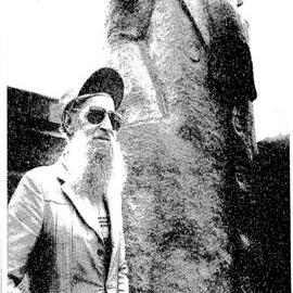  Greymouth personality, Mr Trevor Bryan, bears a remarkable resemblance to the statue of a sea captain on the town's floodwall