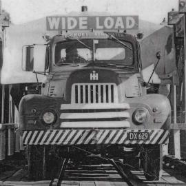 A dozer on Croft's truck crossing what looks like the Arahura bridge.