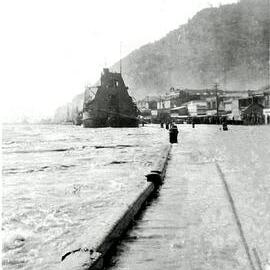 This photo shows the Grey River in flood, coming over the top of the Wharf