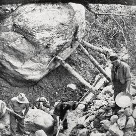 Mr G Morgan (right), the Government Supervisor,assisting young Prospectors on their claim.Murchison District.1933.