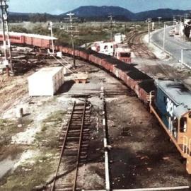 Train coming off the S bend bridge into the Greymouth river siding. *PHOTO ALBUM*