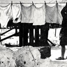Braving the elements on washing day.1931.