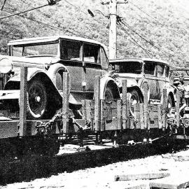 Vehicles loaded onto trucks for transportation from Arthurs Pass to Otira .1934.