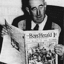 Mr Watkin reading a 1905 comic at his Cobden home.