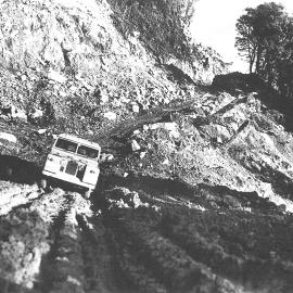 "Rugged conditions, even for four-wheel-drive vehicles, near Grave Creek, in the last four-mile contract on the Haast route." 1965.