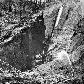 Men sluicing for gold in a pit near Westport.1898.