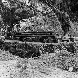 Logging trucks Oparara valley road near Karamea . late 1960`s.