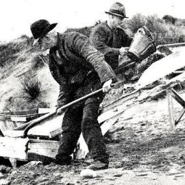  Gillespies beach - The chute is coated with quicksand which retains the gold, while the water and sand passes into the trough.1930.