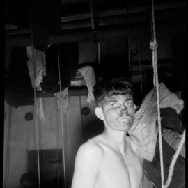 An unidentified miner in the Denniston bath-house. 1945.
